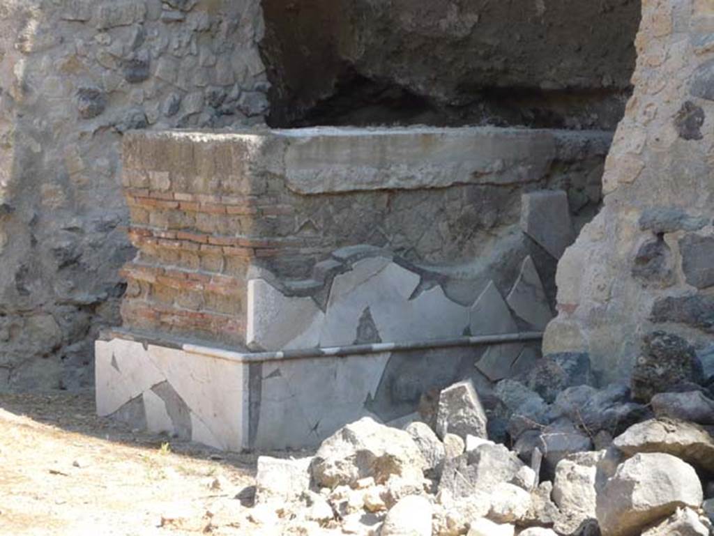 Herculaneum. August 2013. Detail of base on north-west side of four-sided Arch. Photo courtesy of Buzz Ferebee.